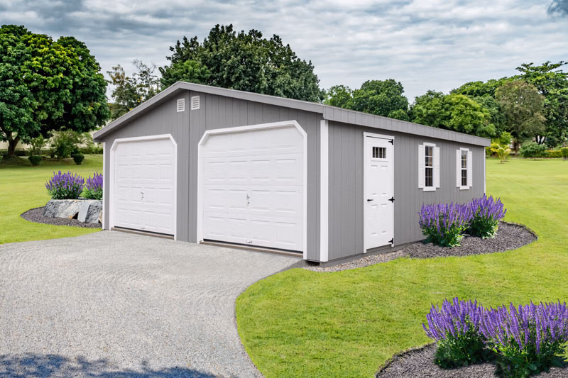 Gray and white 2 car prefab garage with landscaped lawn