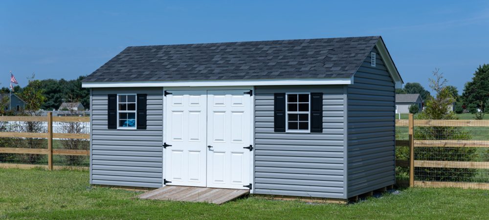 blue shed in backyard by fence